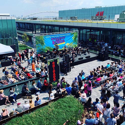 crowded outdoor stage performance at Empire Outlets