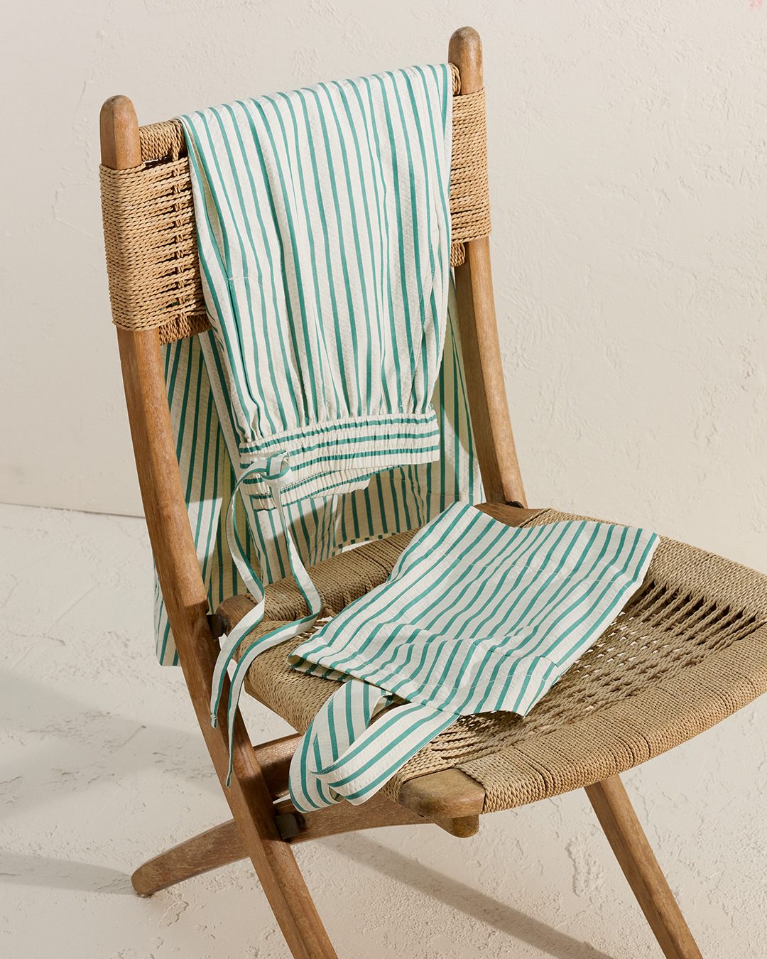 EO BANANA REPUBLIC OUTLET a Banana Republic striped summer outfit over a rattan chair